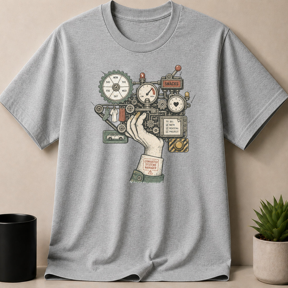 Grey t-shirt with illustration of a mechanical arm titled "Exhausted Systems Manager."