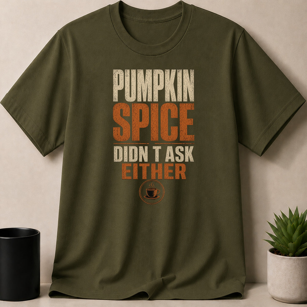 Green t-shirt with distressed text: "PUMPKIN SPICE DIDN'T ASK EITHER"