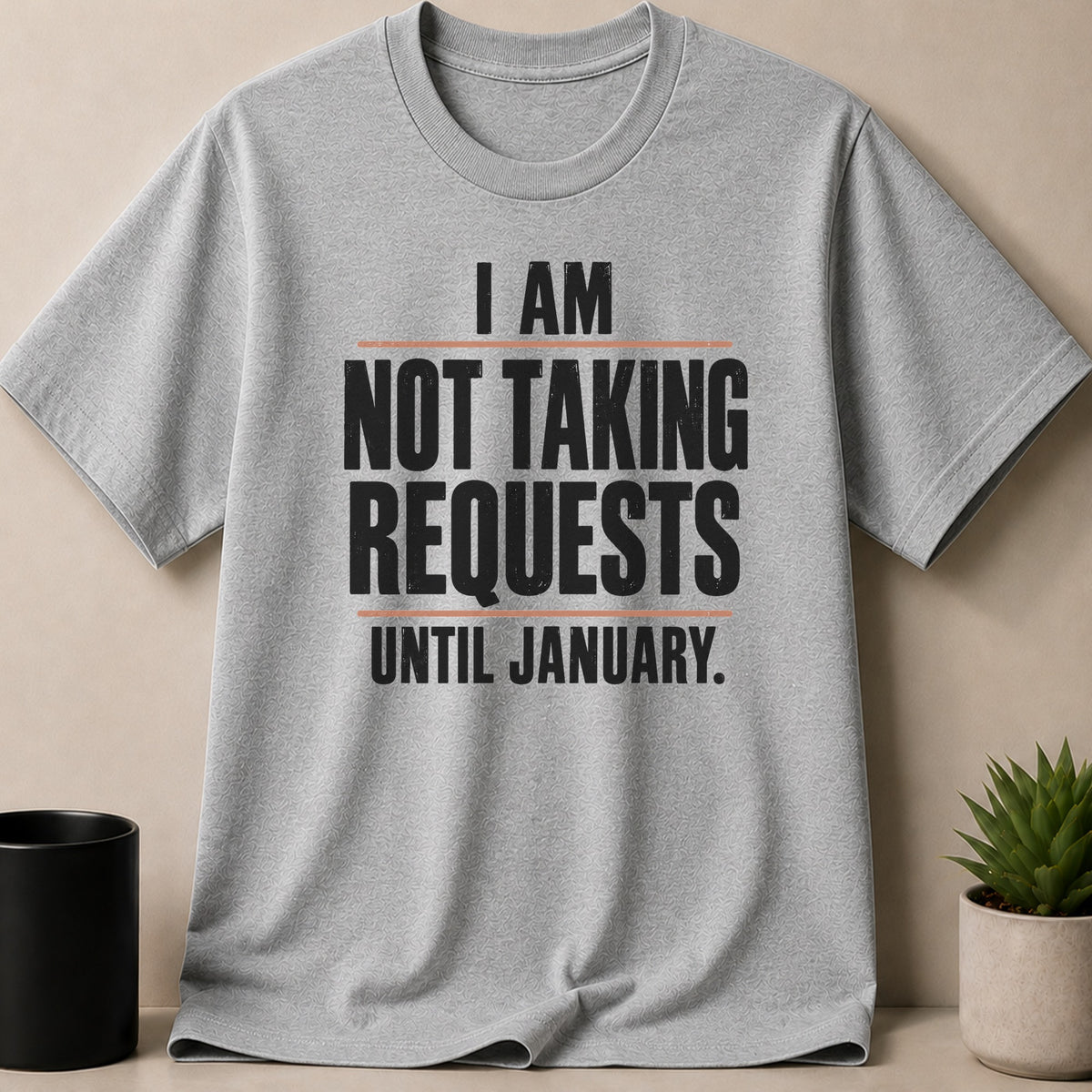 A grey t-shirt featuring the black text, I am not taking requests until January.
