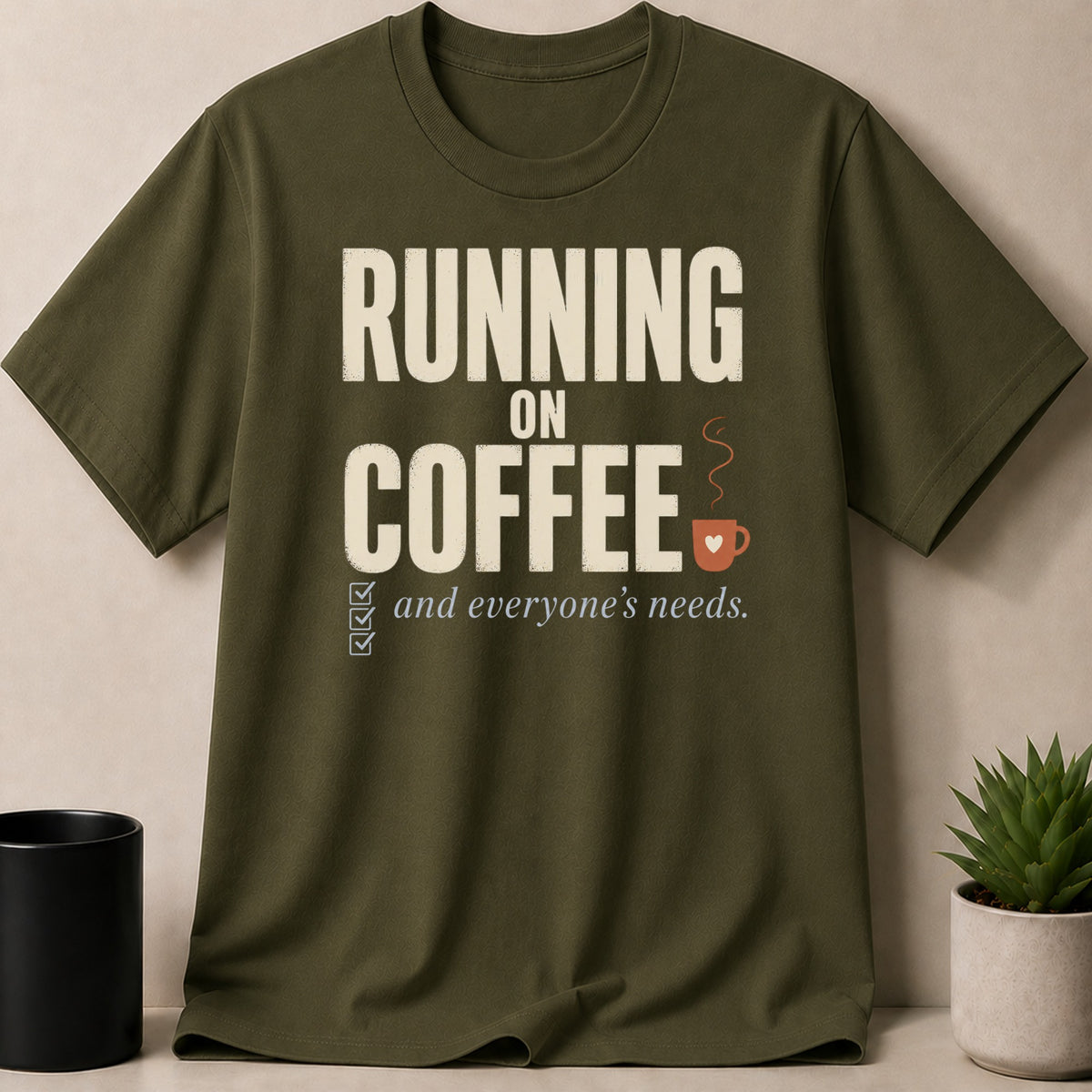 Olive green t-shirt with "RUNNING ON COFFEE and everyone's needs." text.