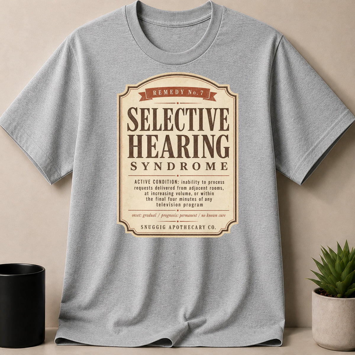 Grey t-shirt with a vintage label graphic for "Selective Hearing Syndrome".