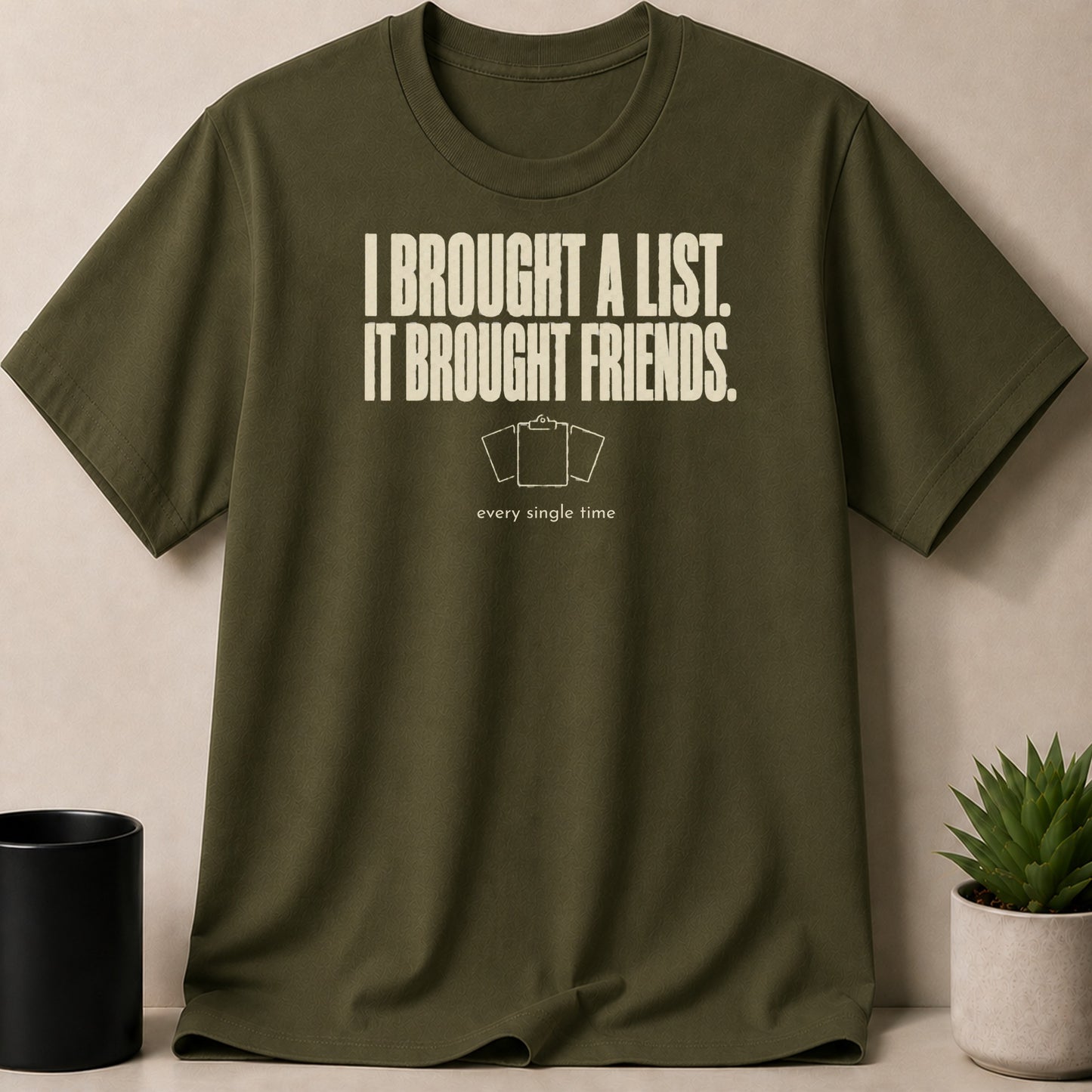 Olive green t-shirt with white text "I BROUGHT A LIST. IT BROUGHT FRIENDS."