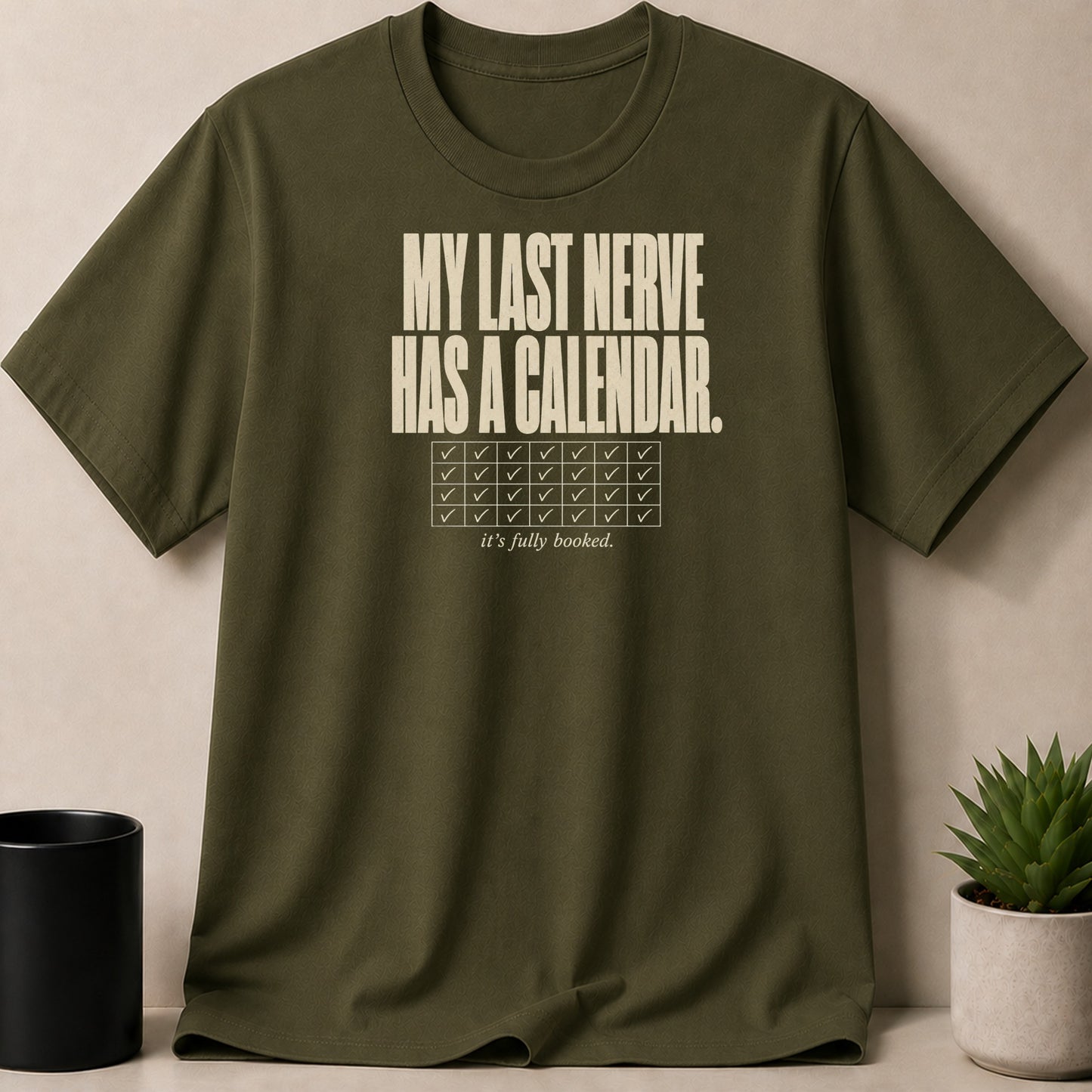 Olive green t-shirt with text "MY LAST NERVE HAS A CALENDAR. it's fully booked."