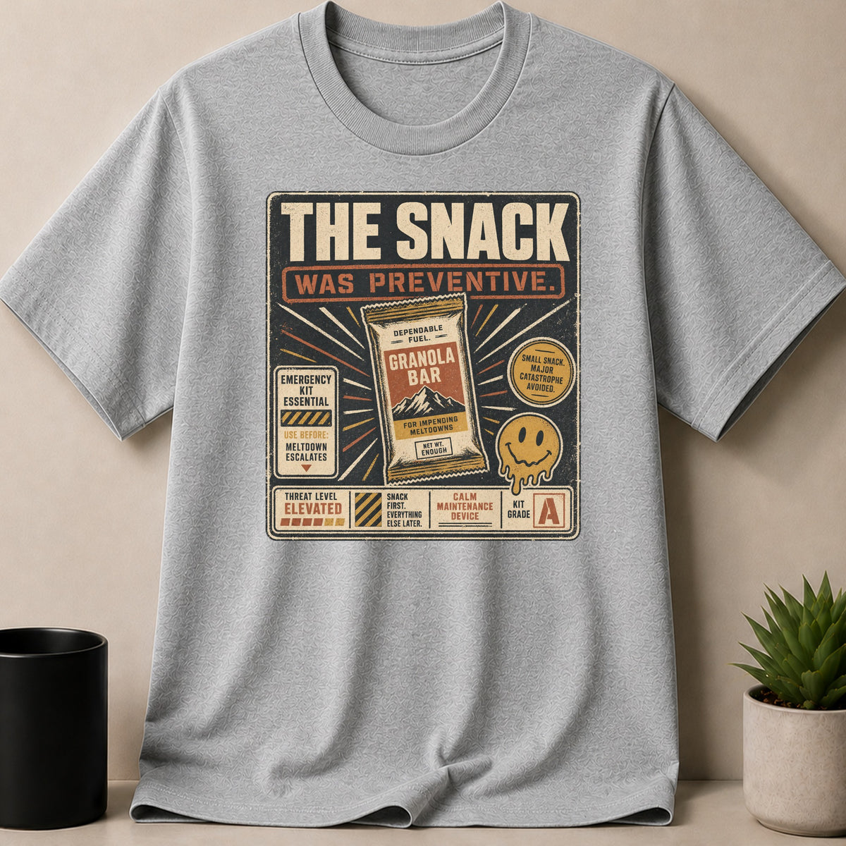 Gray t-shirt with "The Snack Was Preventive" design featuring a granola bar.
