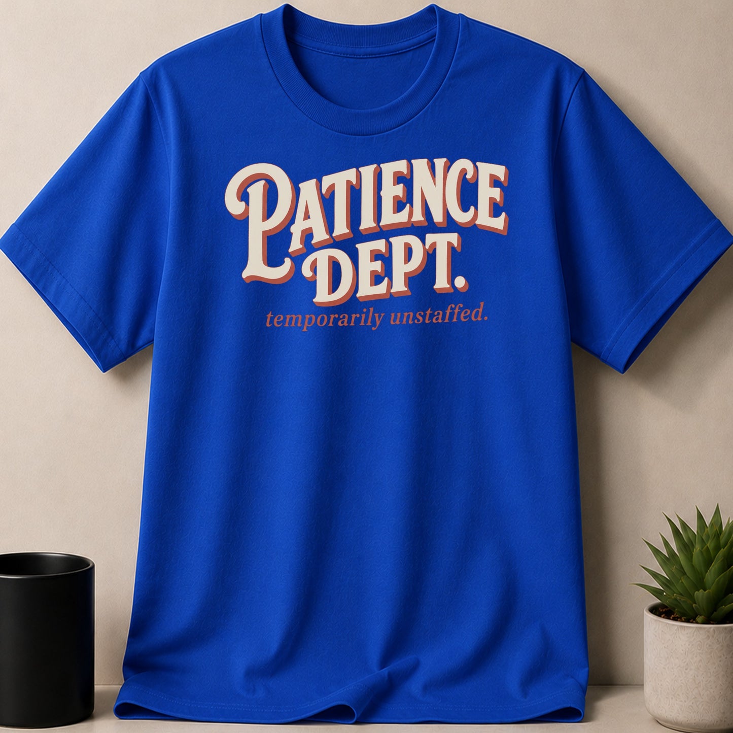 Blue t-shirt with "Patience Dept. temporarily unstaffed." text in vintage font.