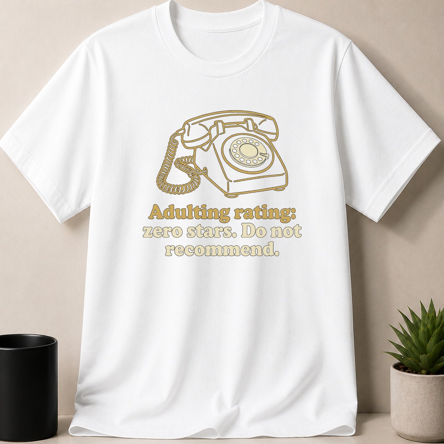 White t-shirt with a gold line drawing of a rotary phone and text.