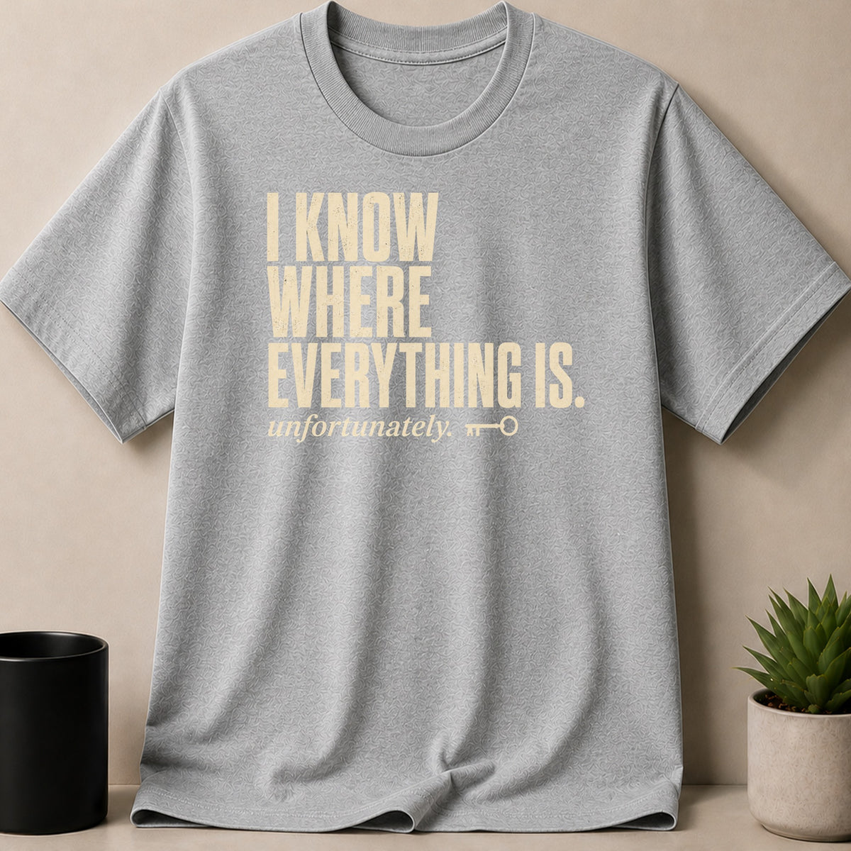Grey t-shirt with "I KNOW WHERE EVERYTHING IS. unfortunately." text and a key graphic.