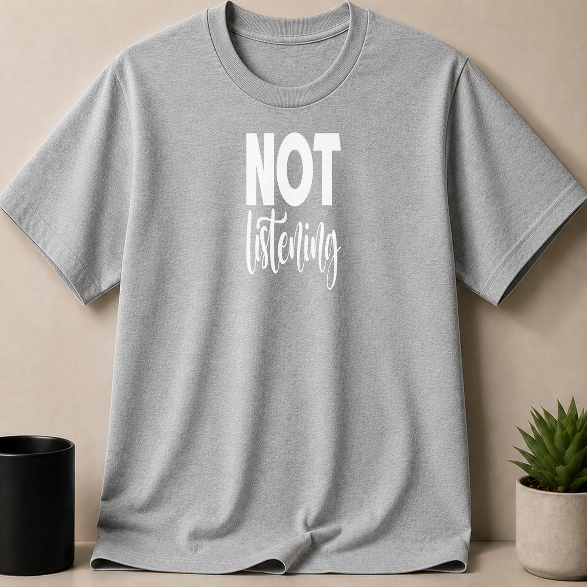 Grey t-shirt with white text "NOT listening"