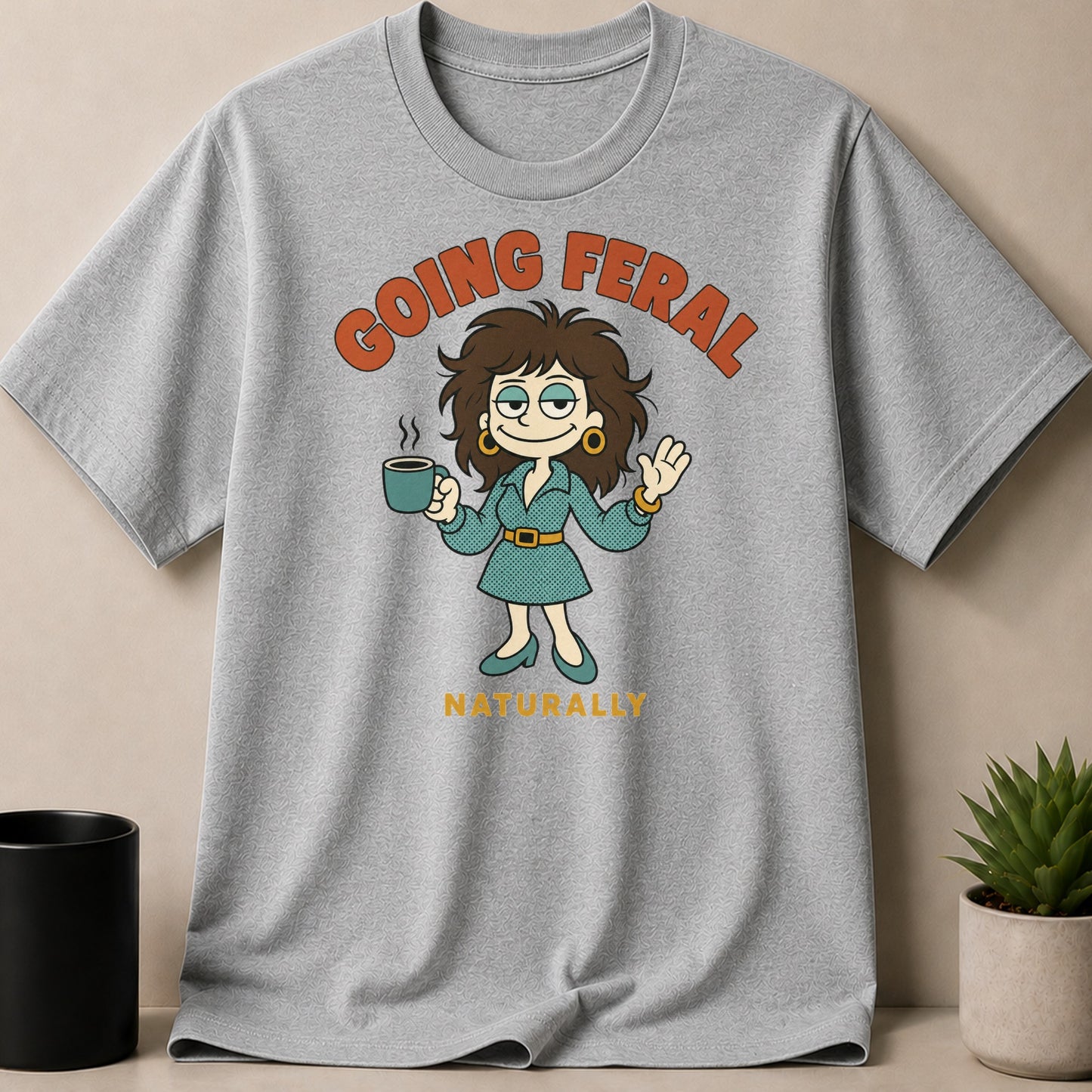 Cartoon woman with coffee mug and text "GOING FERAL NATURALLY" on grey t-shirt.