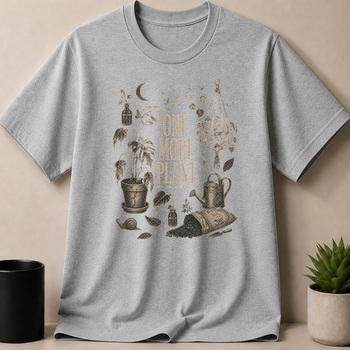 Gray t-shirt with "One More Plant" text and vintage botanical illustration.