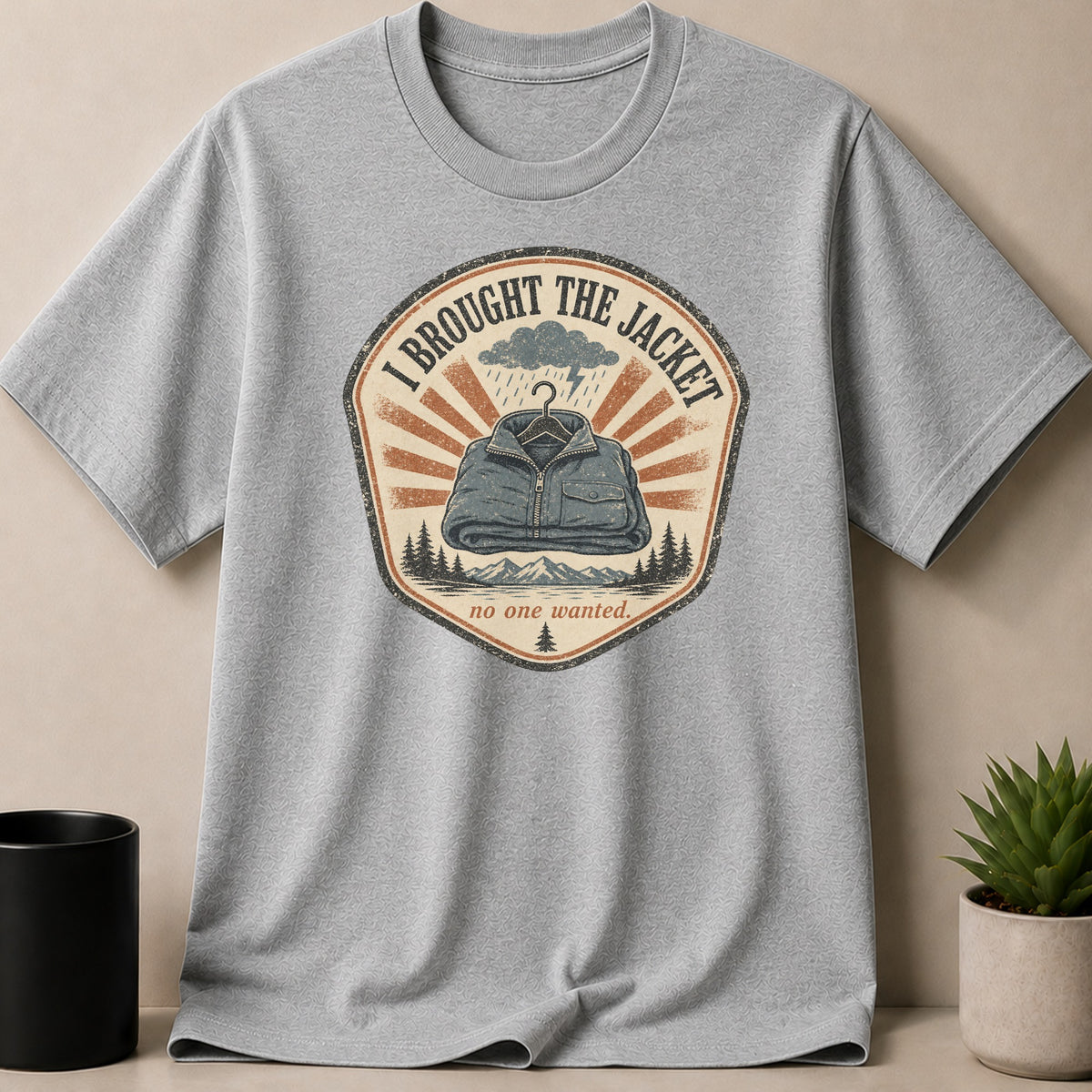 Grey t-shirt with vintage graphic: "I BROUGHT THE JACKET no one wanted."