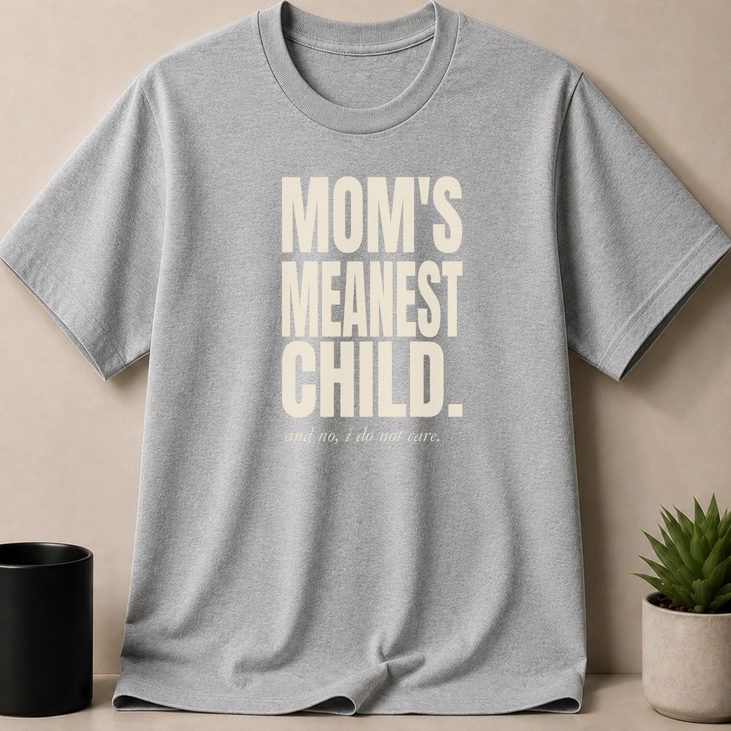 Grey t-shirt with text "MOM'S MEANEST CHILD. and no, i do not care."