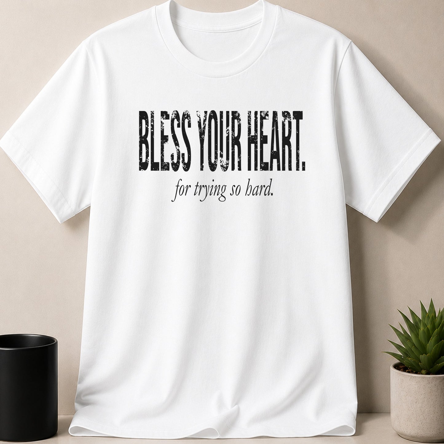 White t-shirt with "BLESS YOUR HEART, for trying so hard." text.