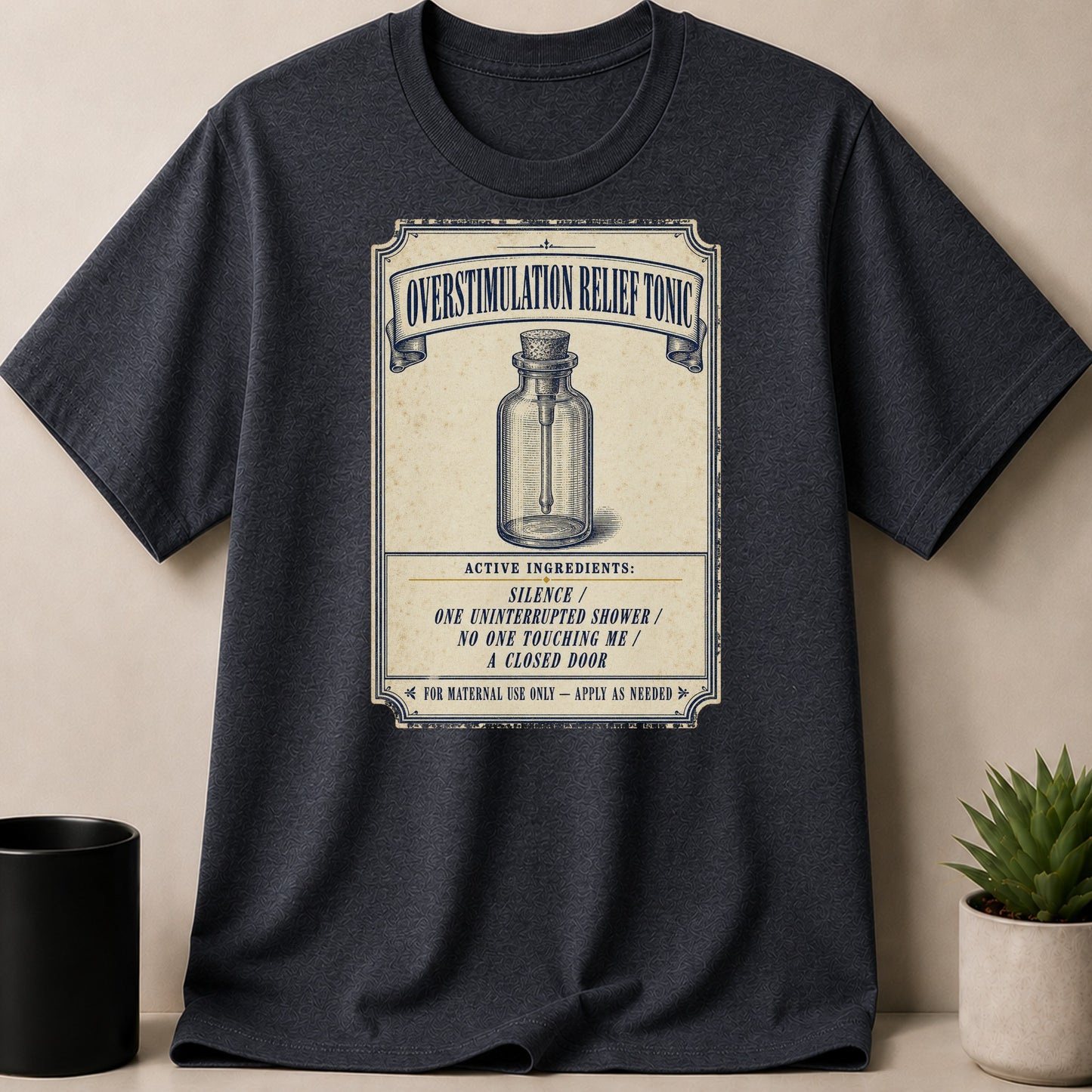 Dark t-shirt with "Overstimulation Relief Tonic" graphic and ingredients list.