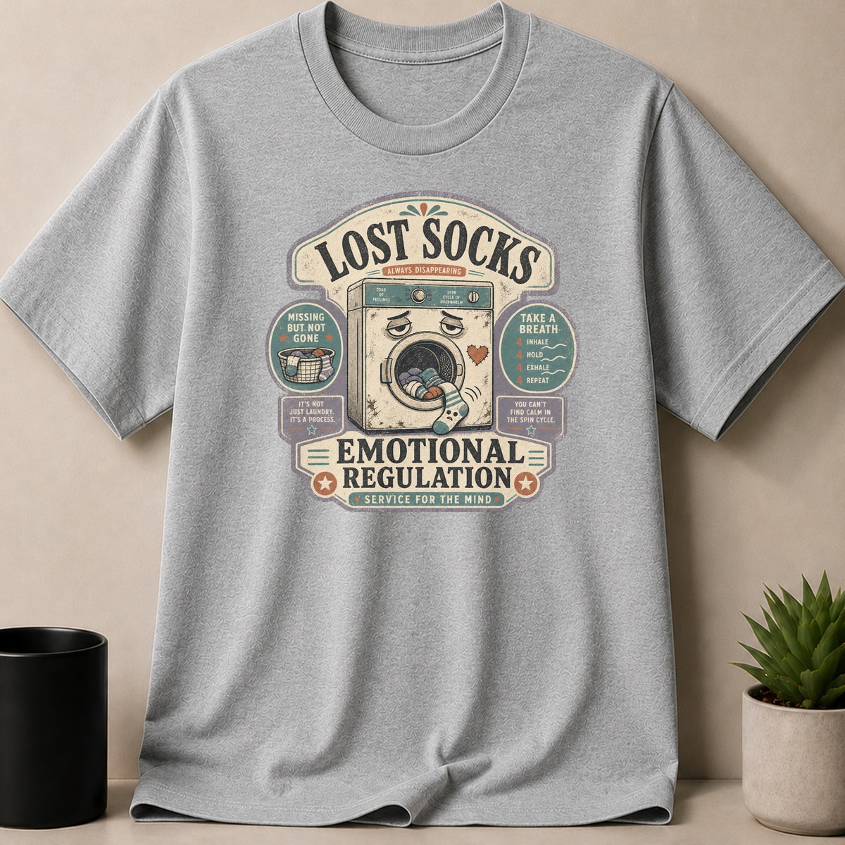 Sport Grey t-shirt — Lost Socks text with washing machine, basket and sock graphics, and 'Emotional Regulation' slogan.