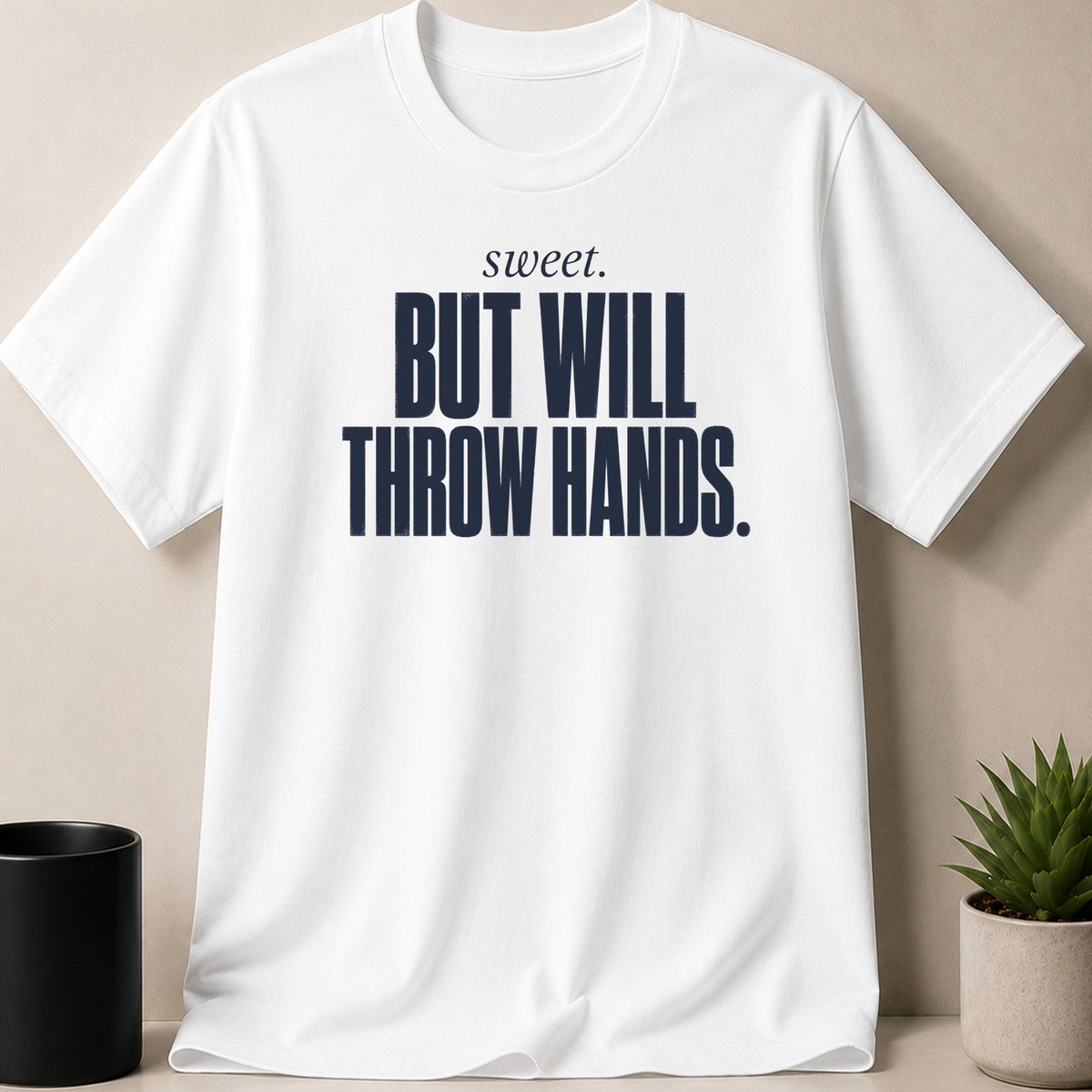 White t-shirt with navy text "sweet. BUT WILL THROW HANDS."
