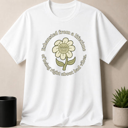 White t-shirt with a round graphic of a tired flower stating "Exhausted from a lifetime of being right about bad vibes."