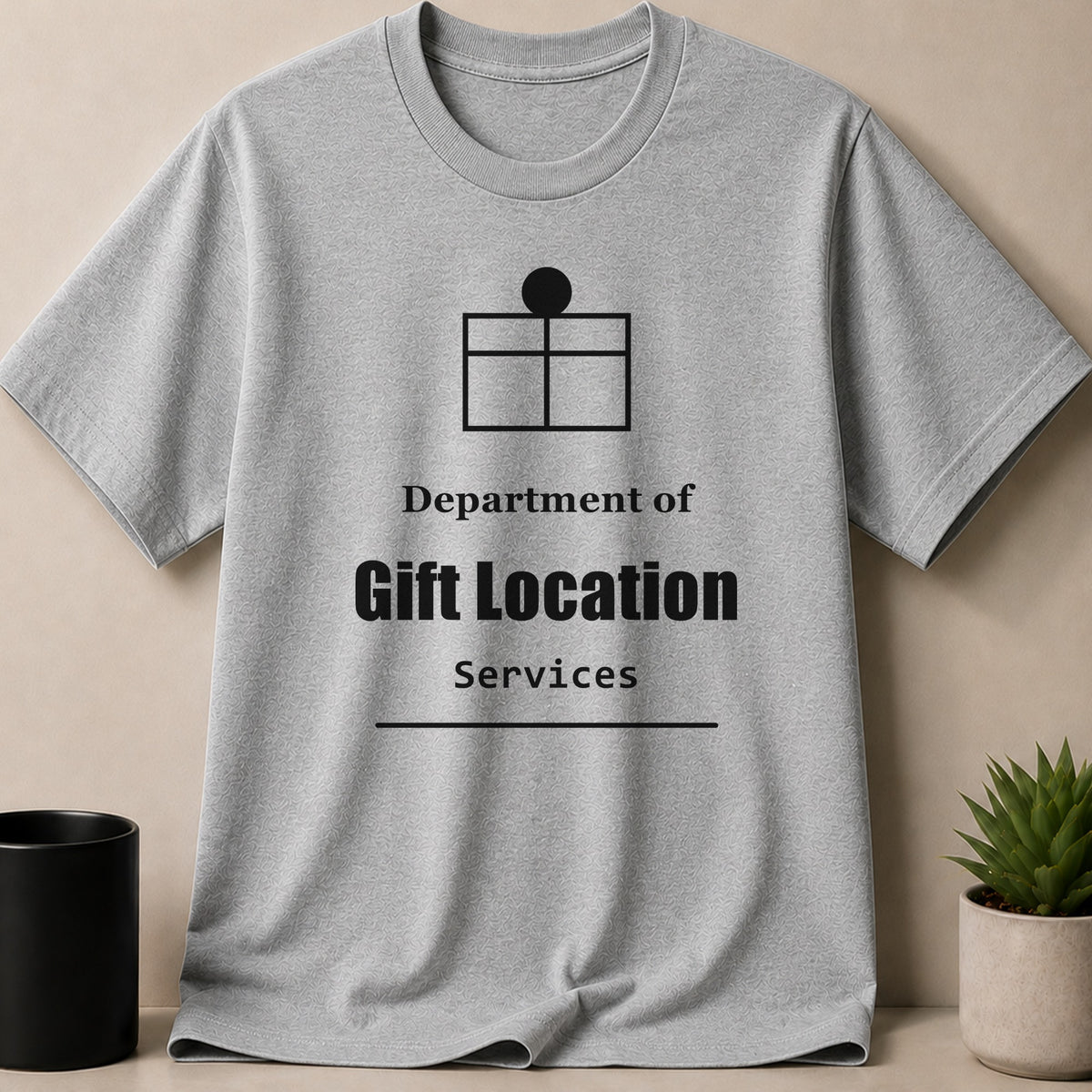 Grey crewneck t-shirt with a black gift icon and text reading Department of Gift Location Services.