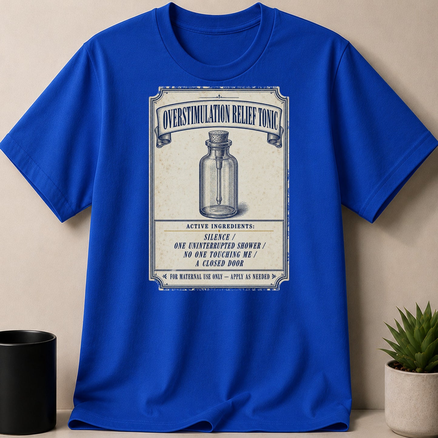 Blue t-shirt with "Overstimulation Relief Tonic" label featuring a bottle and ingredients.