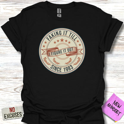 Black t-shirt with "Faking It Till I Figure It Out Since 1983" graphic.
