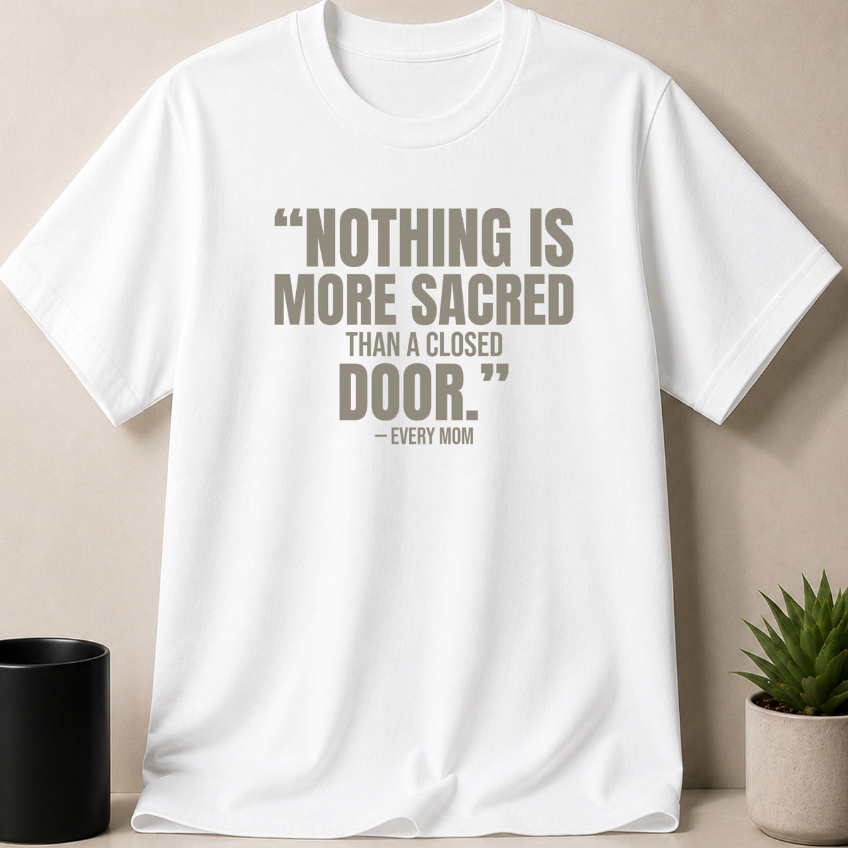A white t-shirt featuring the printed text, "NOTHING IS MORE SACRED THAN A CLOSED DOOR."