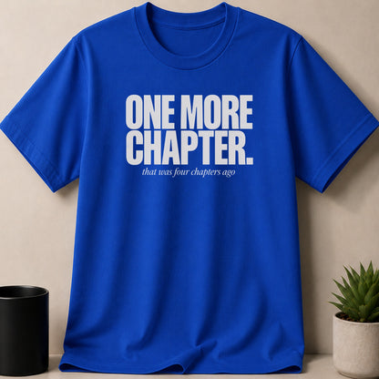Blue t-shirt with white text "ONE MORE CHAPTER. that was four chapters ago."
