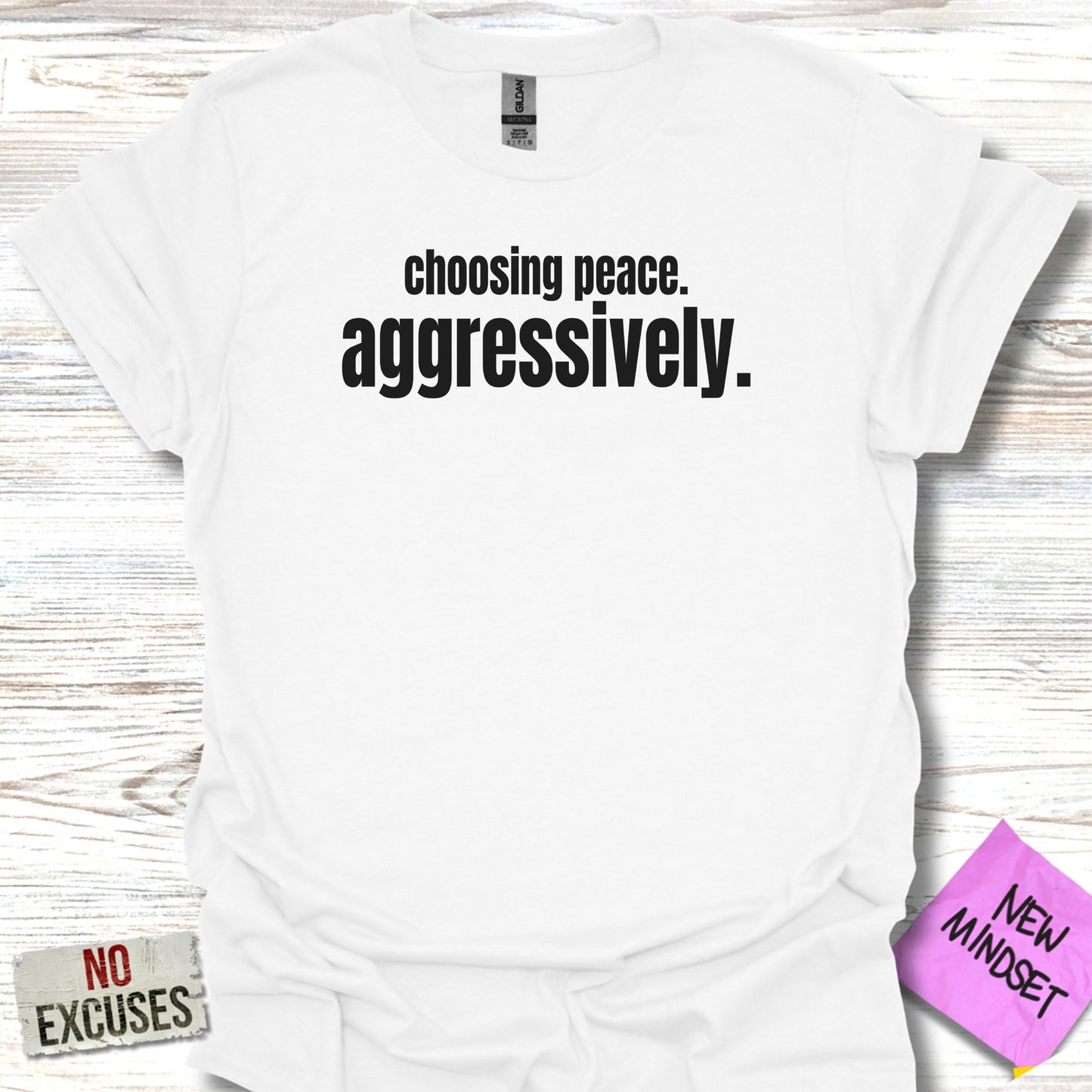 White t-shirt with black text: "choosing peace. aggressively."