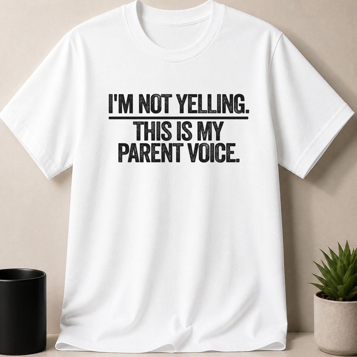 White t-shirt with black distressed text "I'M NOT YELLING. THIS IS MY PARENT VOICE."