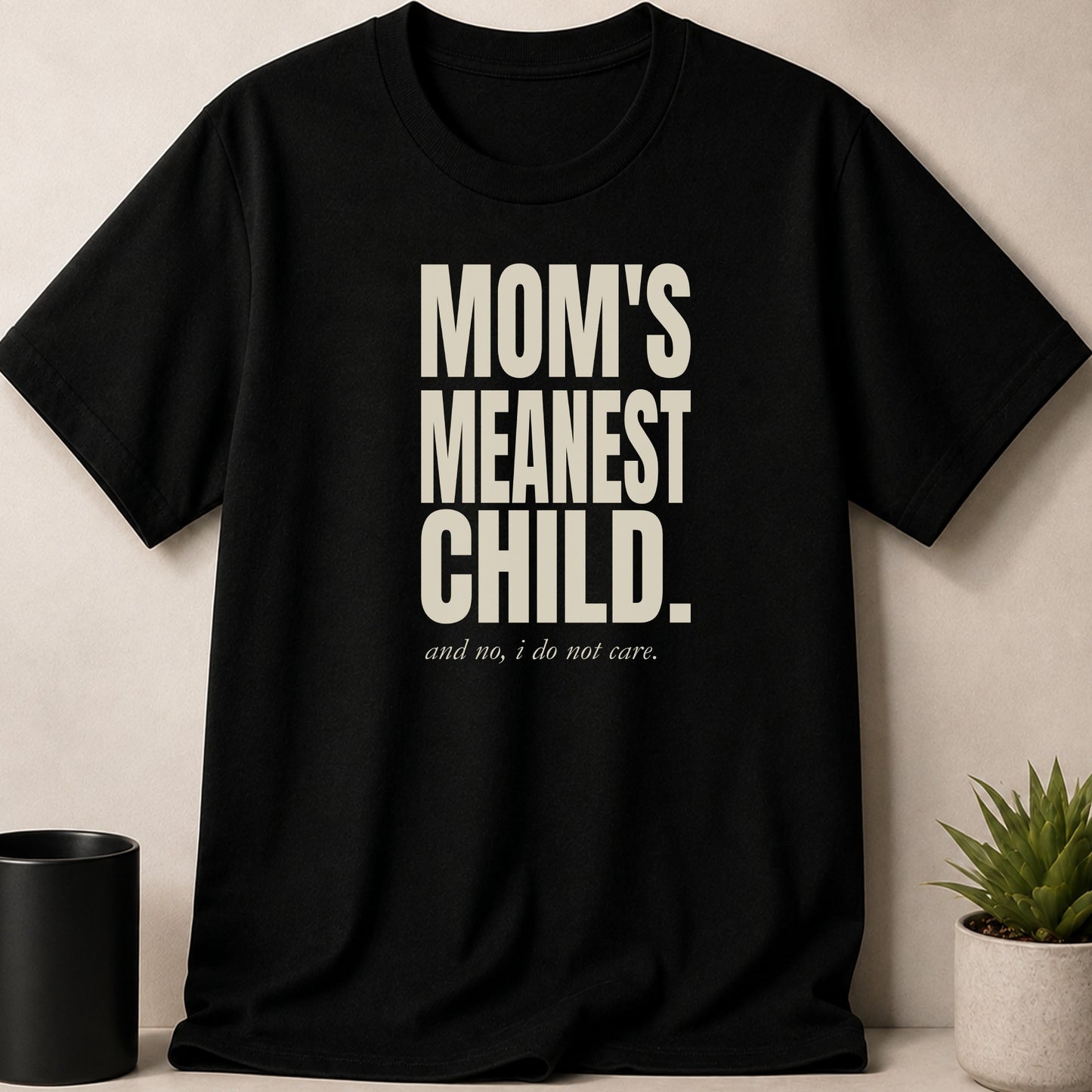 Black t-shirt with "MOM'S MEANEST CHILD." and "and no, i do not care." text.