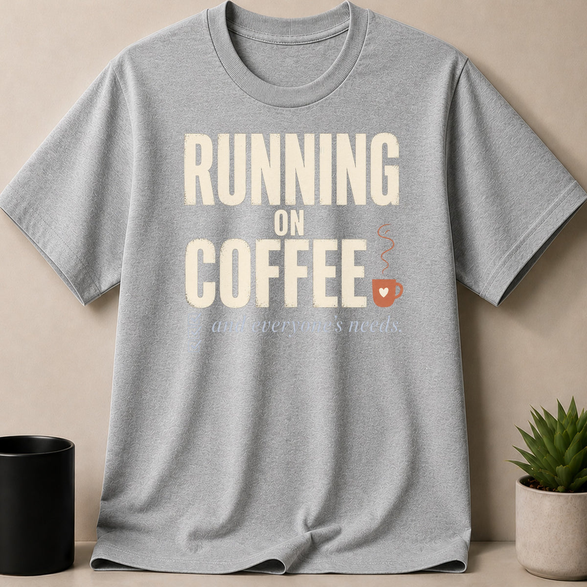 Grey t-shirt with "RUNNING ON COFFEE and everyone's needs" text and coffee cup graphic.