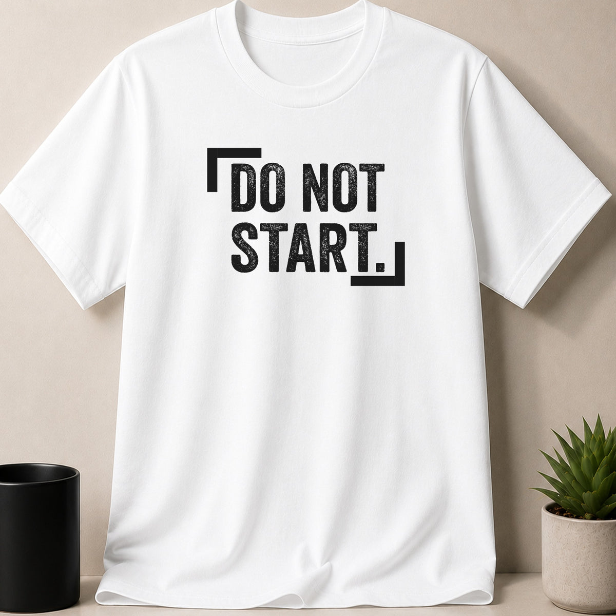 White t-shirt with black distressed text "DO NOT START."