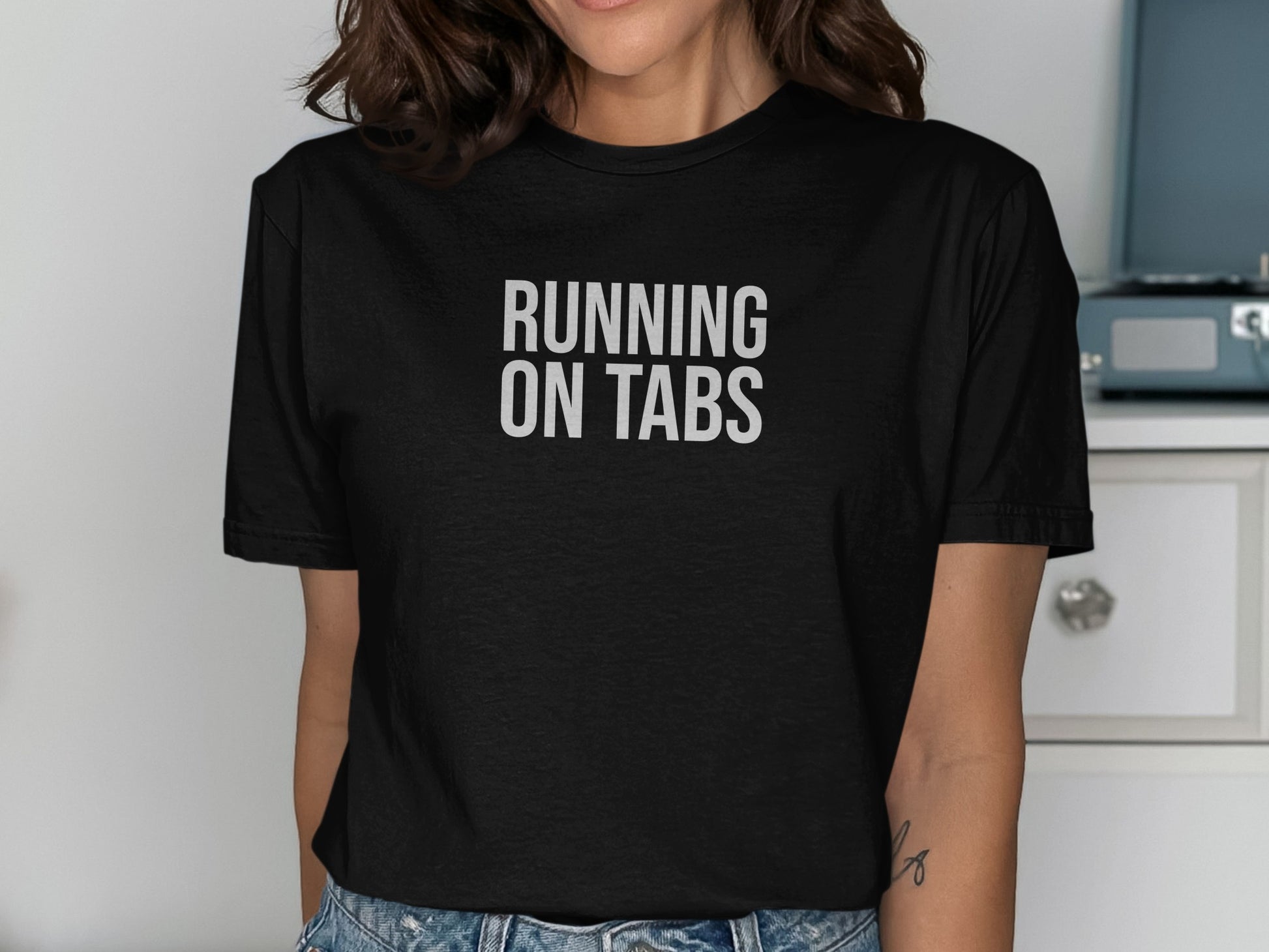 Black t-shirt with "RUNNING ON TABS" printed in white text.