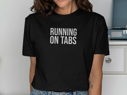 Black t-shirt with "RUNNING ON TABS" printed in white text.
