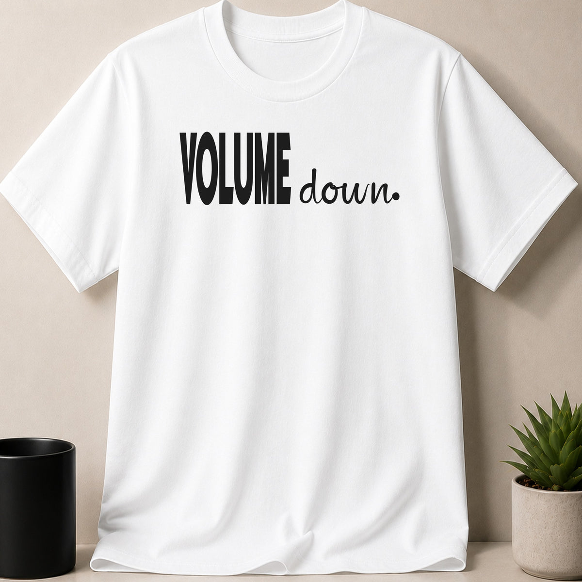 White t-shirt with black text "VOLUME down."
