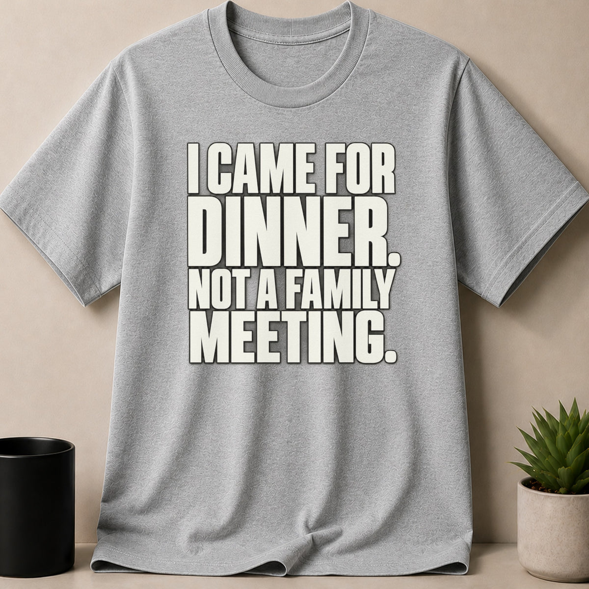 A gray crewneck t-shirt featuring bold white text that reads, I CAME FOR DINNER, NOT A FAMILY MEETING.
