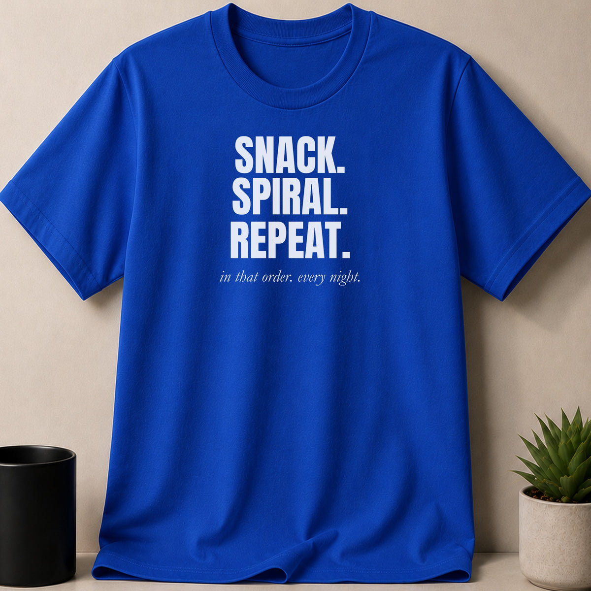 Royal blue t-shirt with white text: "SNACK. SPIRAL. REPEAT. in that order. every night."
