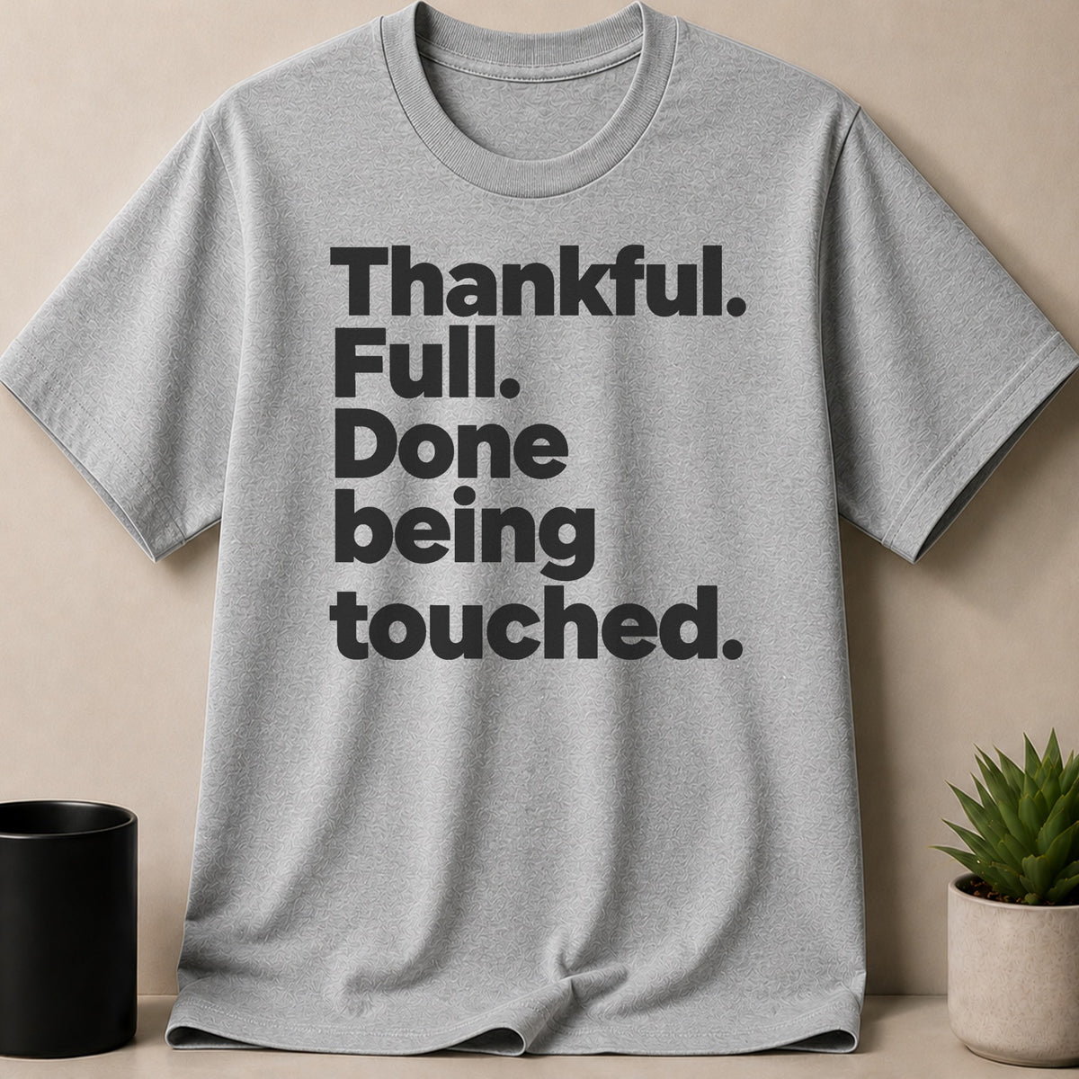 Grey t-shirt with black text "Thankful. Full. Done being touched."