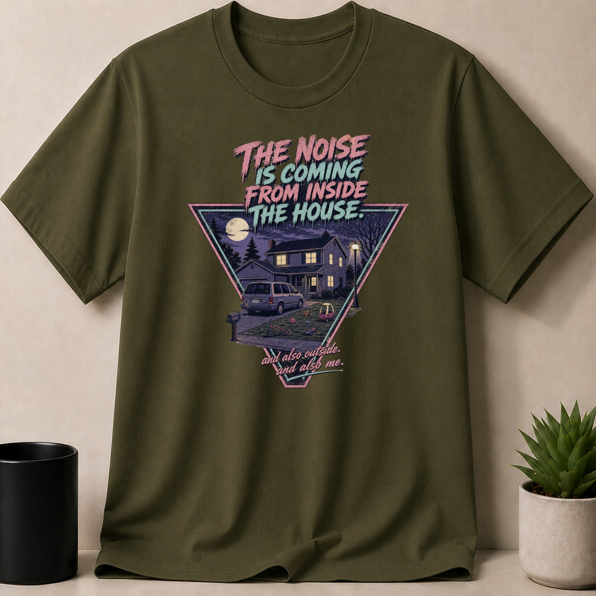Olive green t-shirt with triangle graphic featuring house, van, toys, and text.