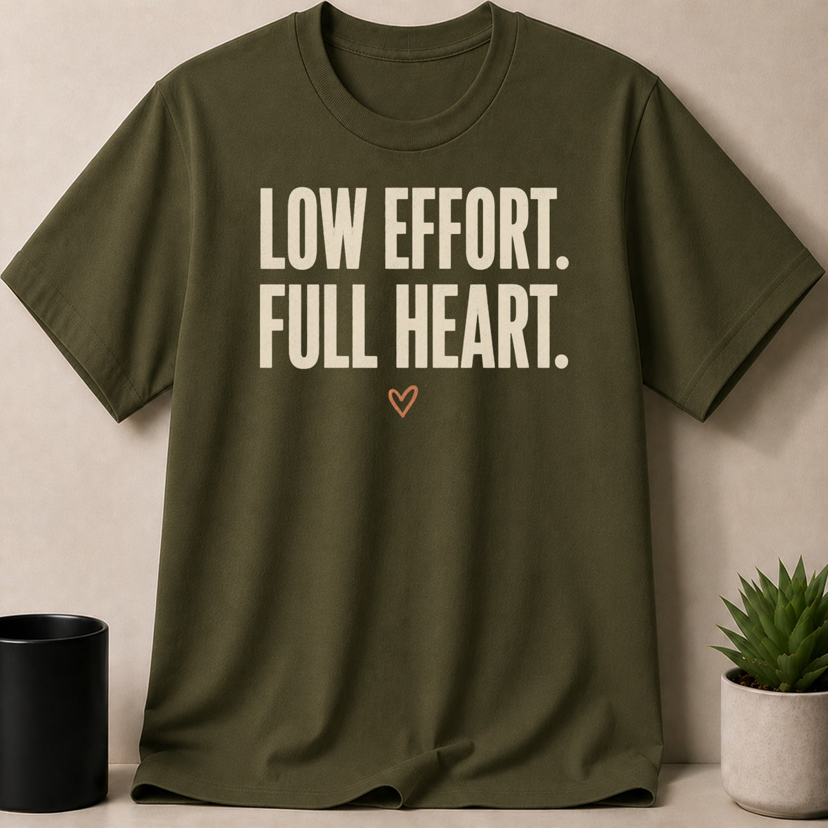 Olive green t-shirt with "LOW EFFORT. FULL HEART." text and a small heart.