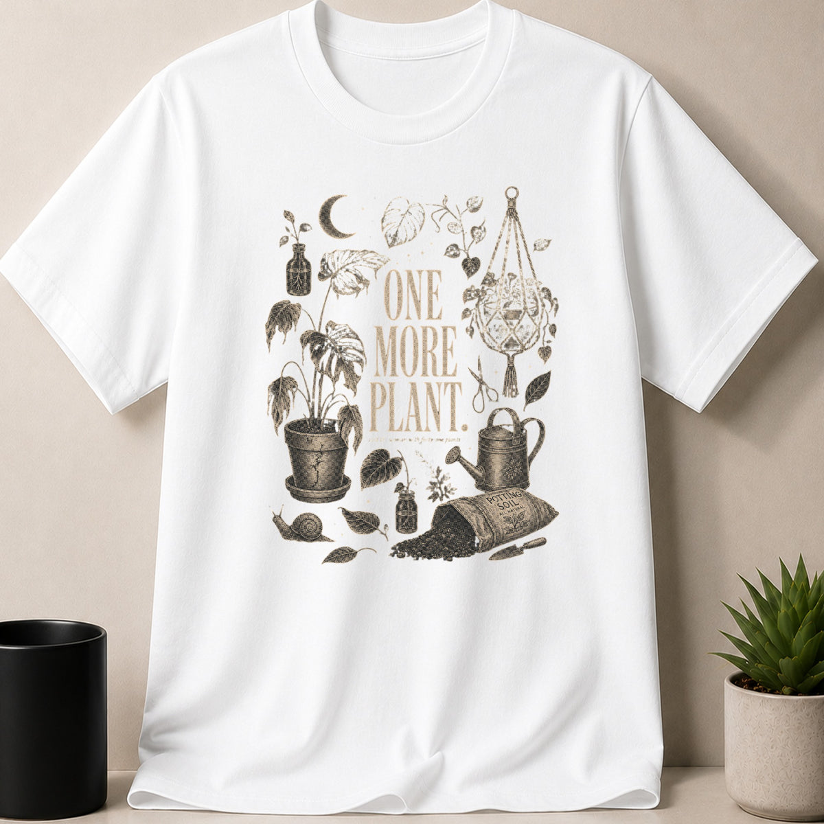 White t-shirt with vintage botanical illustration featuring "ONE MORE PLANT" text and gardening elements.