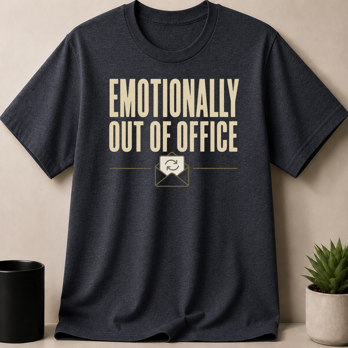 Dark t-shirt with "Emotionally Out of Office" text and an envelope icon.