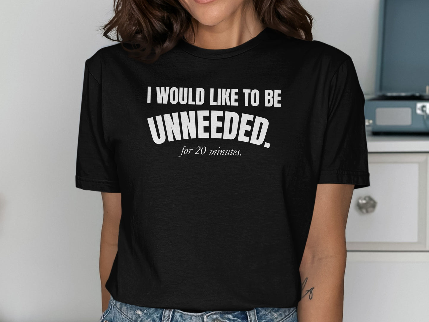 Black t-shirt with white text reading "I WOULD LIKE TO BE UNNEEDED. for 20 minutes."