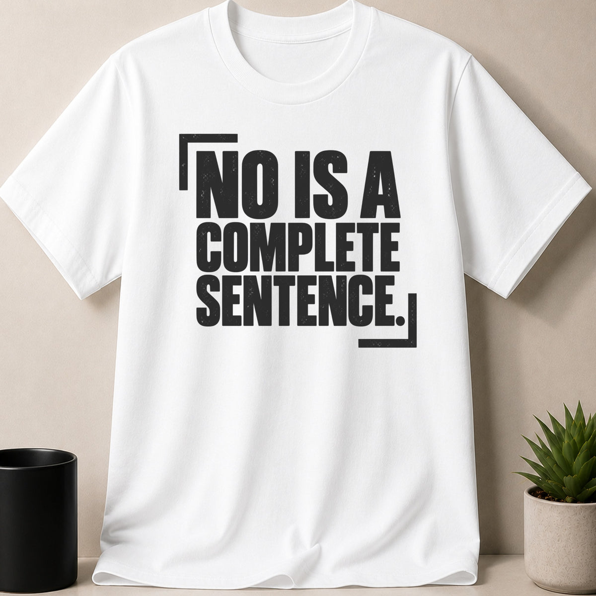 A white short-sleeved t-shirt with black text that reads NO IS A COMPLETE SENTENCE.