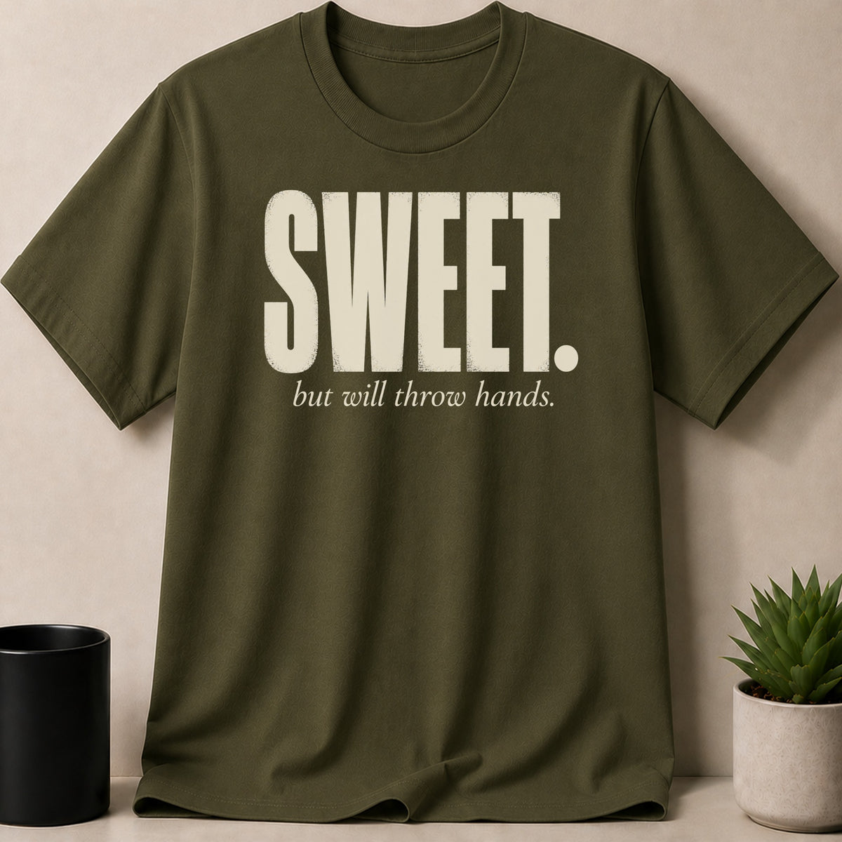 Olive green t-shirt with white text "SWEET. but will throw hands."