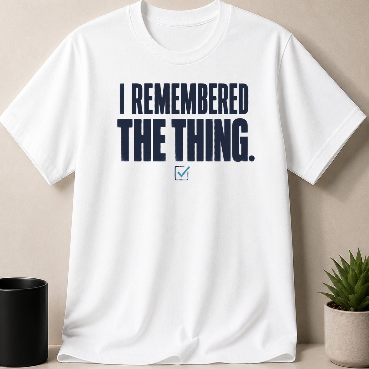 White t-shirt with navy text that reads "I REMEMBERED THE THING."
