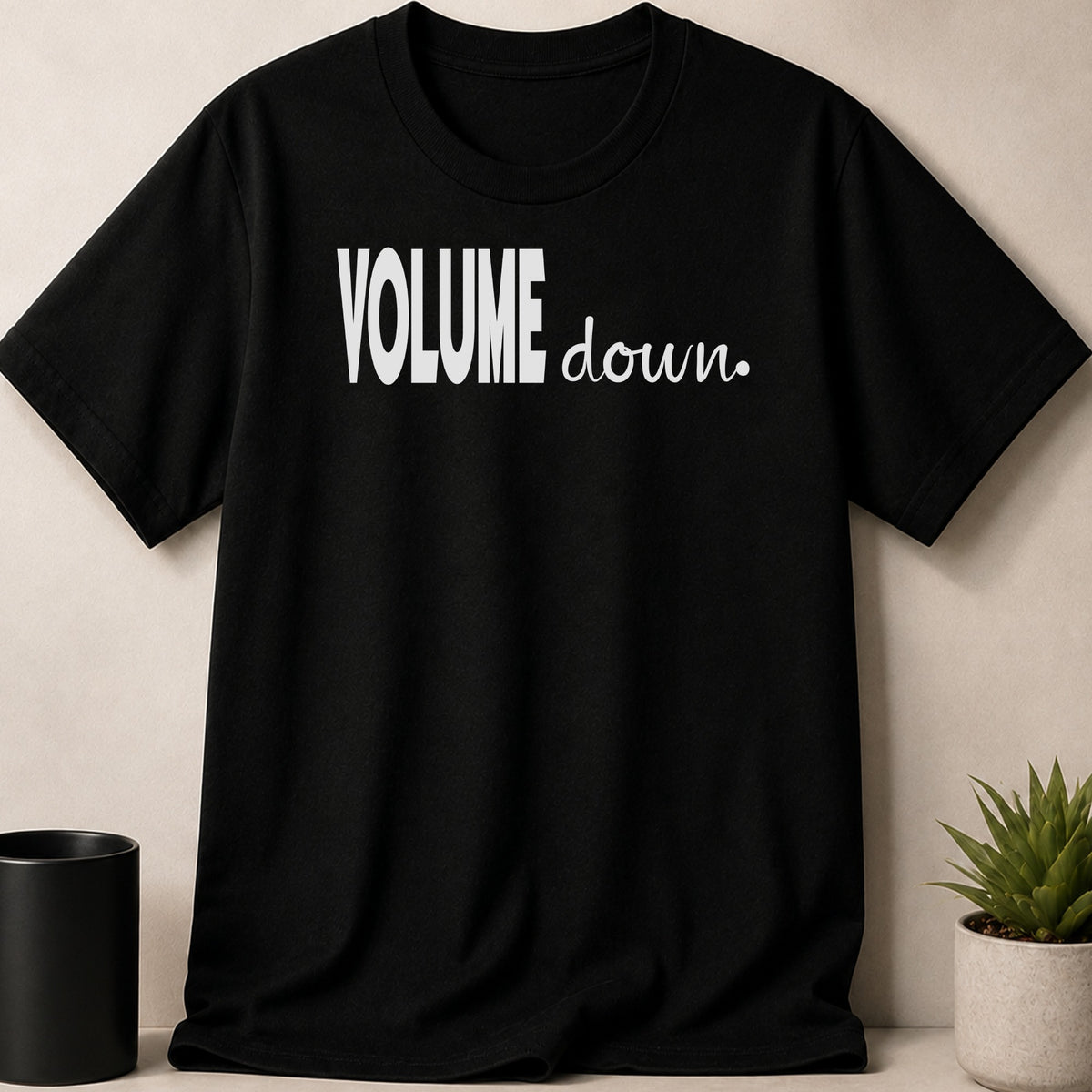 Black t-shirt with white text "VOLUME down."