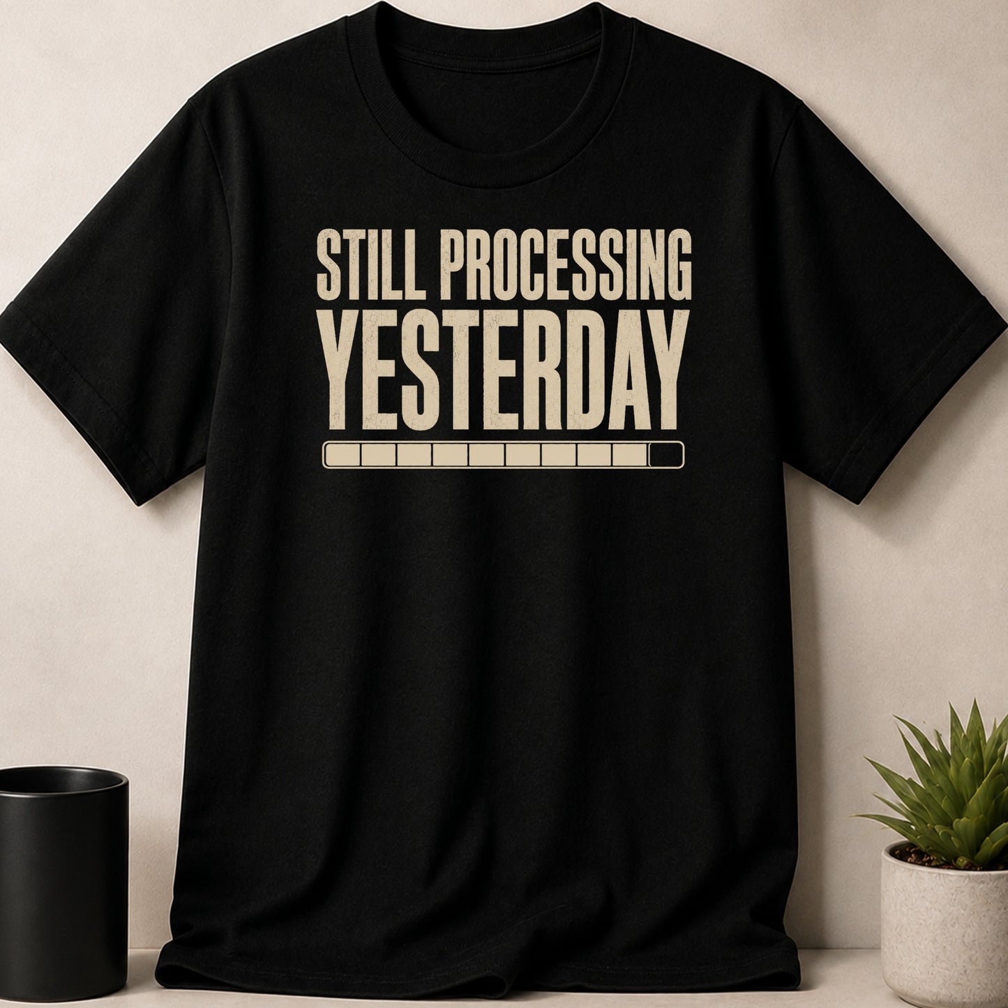 Black t-shirt with "STILL PROCESSING YESTERDAY" text and loading bar.