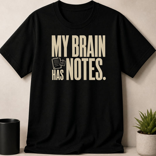 Black t-shirt with text "MY BRAIN HAS NOTES." and a notebook icon.