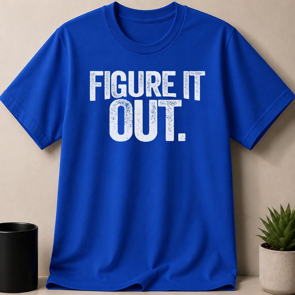 Blue t-shirt with white distressed text reading "FIGURE IT OUT."