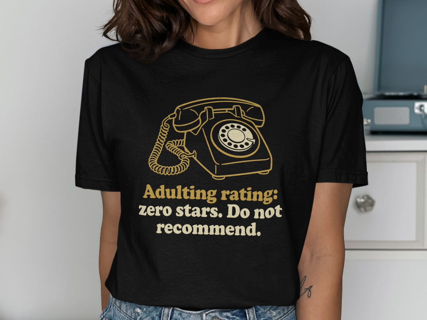 Black t-shirt with graphic of vintage rotary phone and text "Adulting rating: zero stars. Do not recommend."